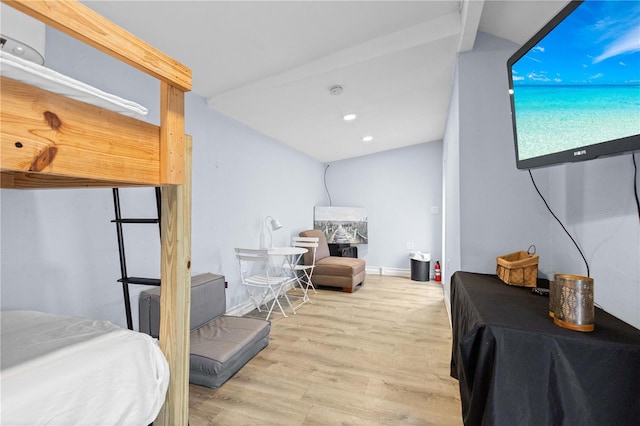 bedroom with lofted ceiling and light wood-type flooring