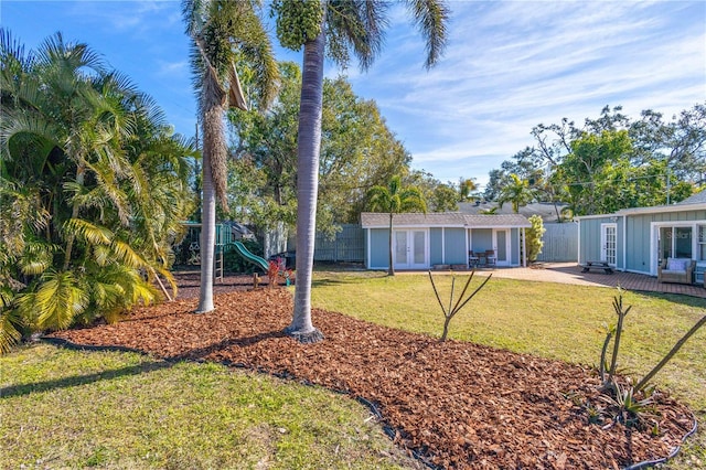 view of yard with french doors, a playground, and a patio