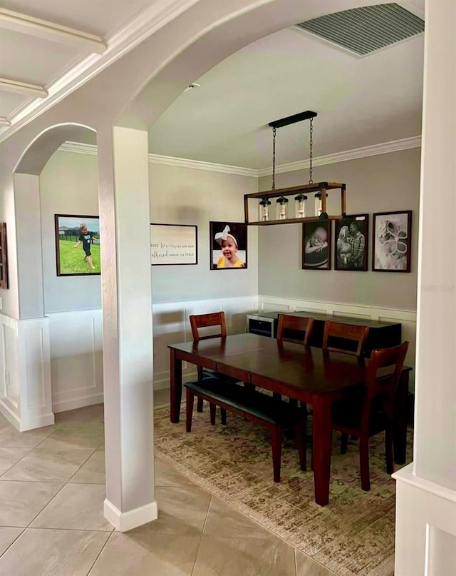 5035 Seafoam Trl, Bradenton, FL 34211 - dining room with ornamental molding, arched walkways, and wainscoting