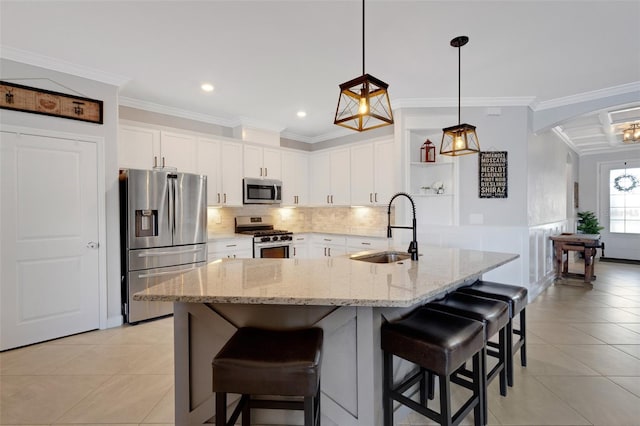 5035 Seafoam Trl, Bradenton, FL 34211 - kitchen with stainless steel appliances, a sink, a kitchen breakfast bar, white cabinetry, and crown molding
