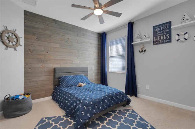 5035 Seafoam Trl, Bradenton, FL 34211 - bedroom with wooden walls, carpet flooring, baseboards, and a ceiling fan