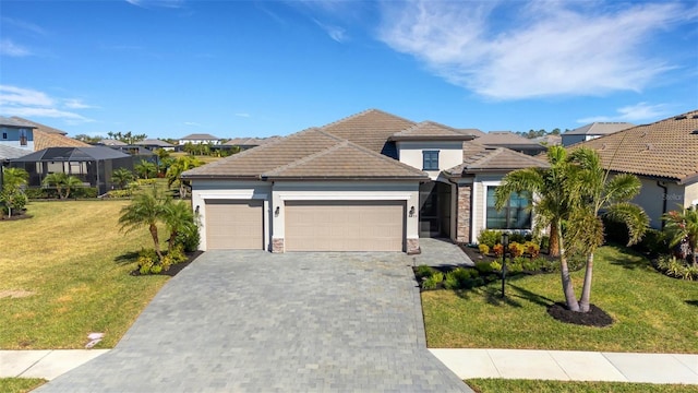 5035 Seafoam Trl, Bradenton, FL 34211 - view of front of house featuring a garage, a residential view, decorative driveway, a front yard, and stucco siding