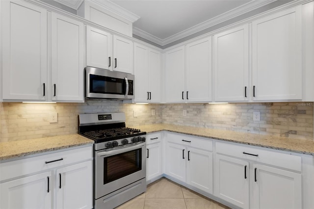 5035 Seafoam Trl, Bradenton, FL 34211 - kitchen featuring stainless steel appliances, white cabinets, crown molding, light tile patterned flooring, and tasteful backsplash