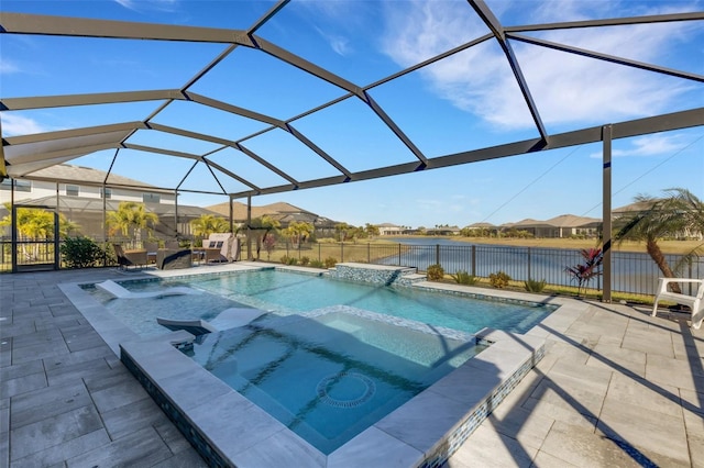5035 Seafoam Trl, Bradenton, FL 34211 - view of swimming pool with a pool with connected hot tub, a patio, a water view, a fenced backyard, and glass enclosure