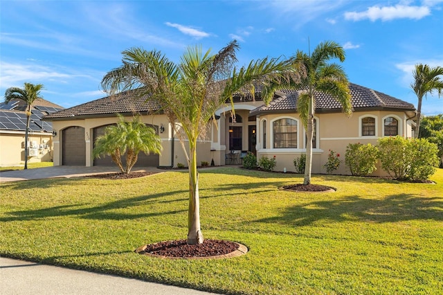 mediterranean / spanish-style home featuring a garage and a front lawn