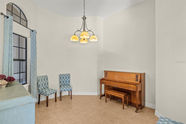 sitting room featuring tile patterned flooring and a notable chandelier