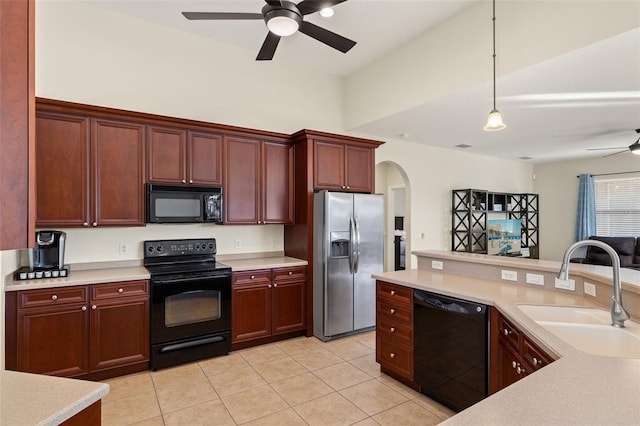 kitchen featuring light tile patterned flooring, sink, decorative light fixtures, ceiling fan, and black appliances