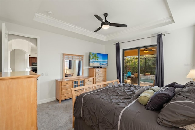 carpeted bedroom featuring crown molding, a raised ceiling, and access to outside