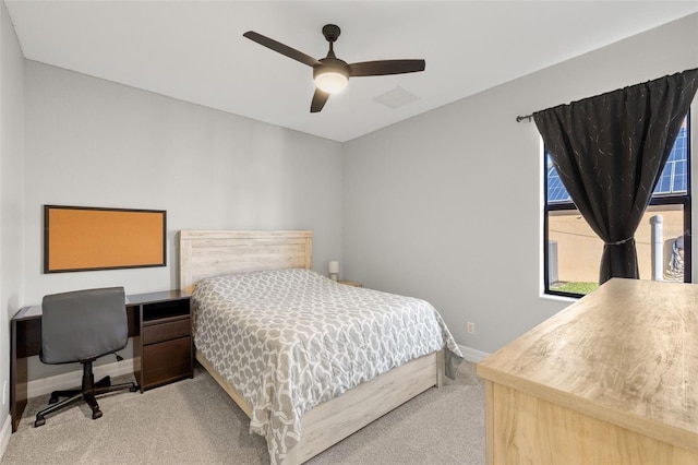 bedroom with ceiling fan and light carpet