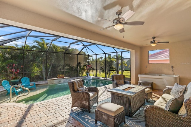 view of patio featuring ceiling fan, an outdoor fire pit, a pool with hot tub, and glass enclosure