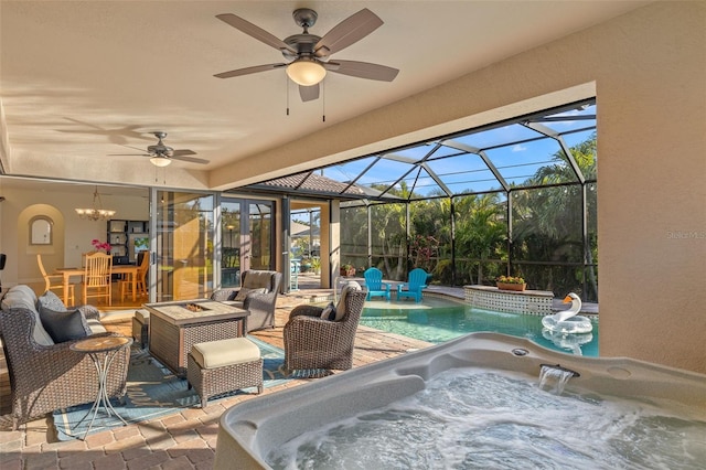 view of patio / terrace with ceiling fan, a lanai, and a fire pit