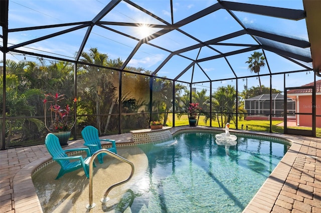 view of pool with a patio and glass enclosure