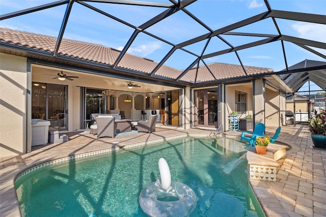 view of swimming pool with a lanai, a patio, and ceiling fan