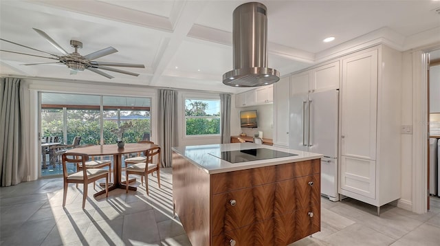 kitchen featuring white cabinetry, a center island, black electric stovetop, island exhaust hood, and high end white fridge