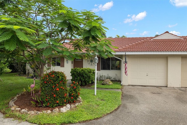 view of front of house with a garage and a front yard