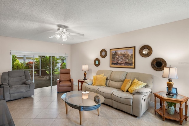 living room with light tile patterned floors, a textured ceiling, and ceiling fan