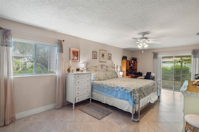 tiled bedroom with multiple windows, a textured ceiling, access to outside, and ceiling fan