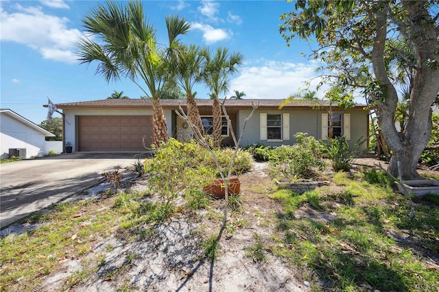 single story home with a garage and central AC