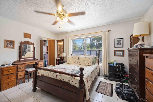 tiled bedroom with ceiling fan and a textured ceiling