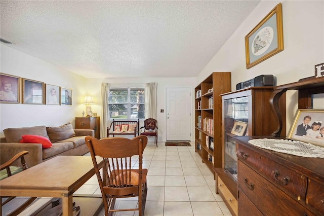 dining area with light tile patterned floors and a textured ceiling