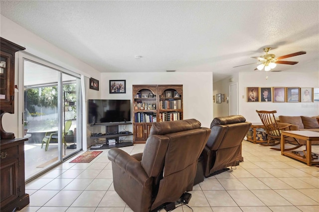 tiled living room featuring ceiling fan and a textured ceiling