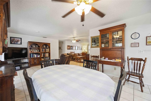 tiled dining space with a textured ceiling