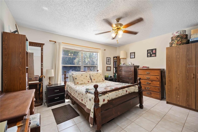 tiled bedroom featuring ceiling fan and a textured ceiling