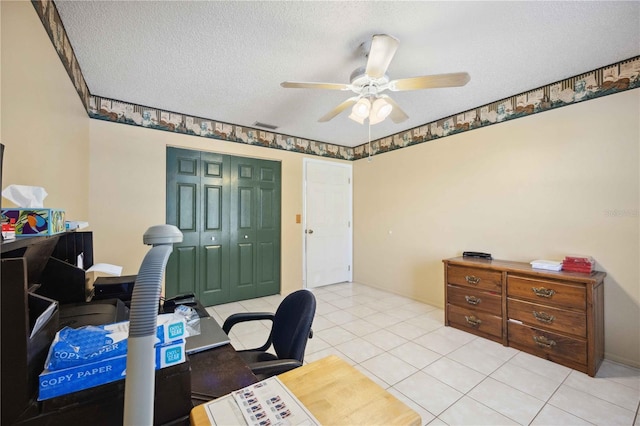 office area with ceiling fan, light tile patterned floors, and a textured ceiling