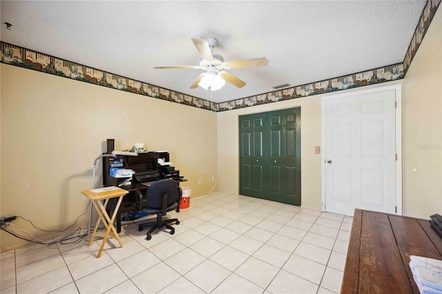 tiled office space with ceiling fan and a textured ceiling