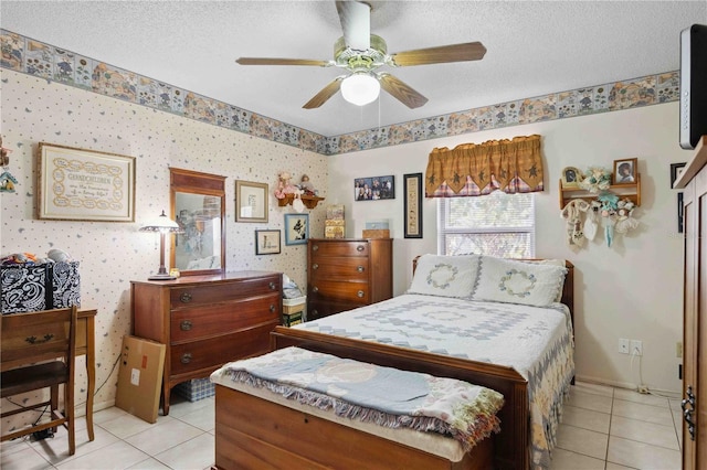 bedroom featuring ceiling fan, a textured ceiling, and light tile patterned floors