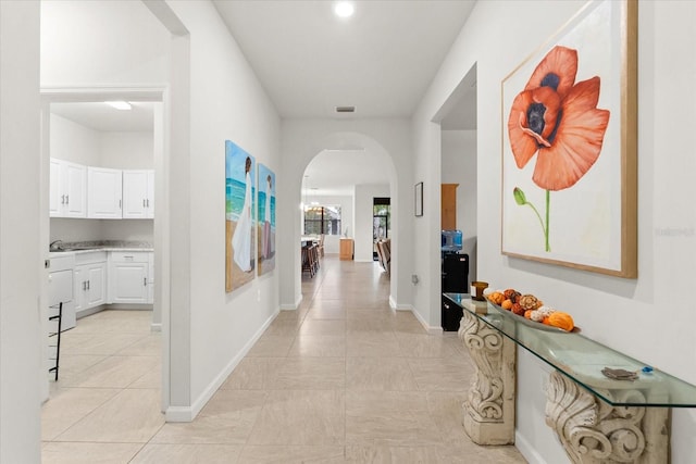 corridor with light tile patterned flooring