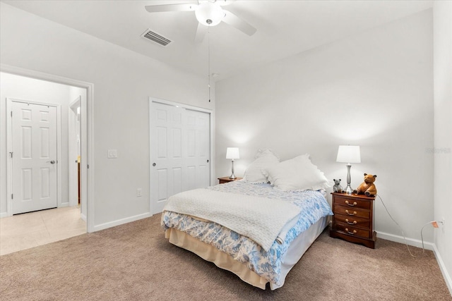 carpeted bedroom featuring ceiling fan and a closet