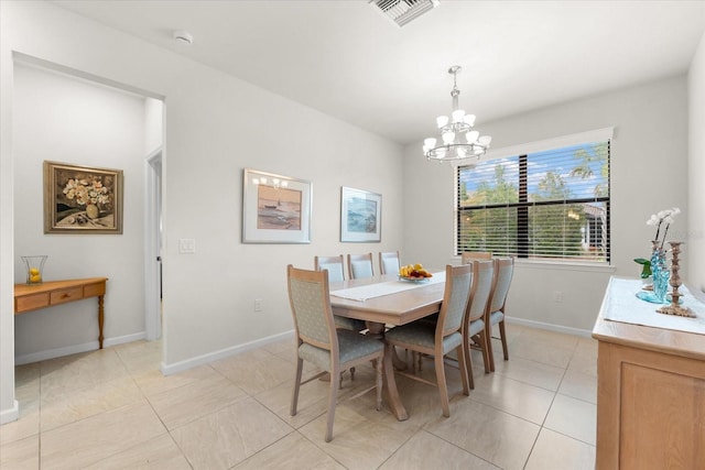 dining room featuring a notable chandelier and light tile patterned flooring