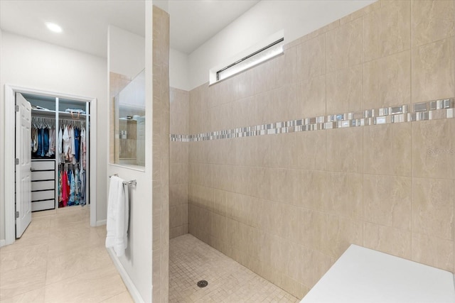 bathroom featuring tile patterned flooring and tiled shower