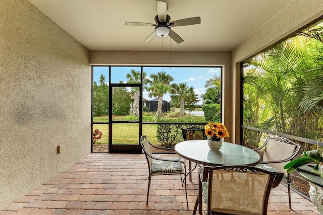 sunroom featuring ceiling fan