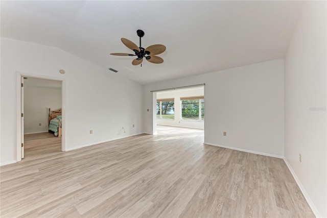 empty room featuring ceiling fan, lofted ceiling, and light hardwood / wood-style floors