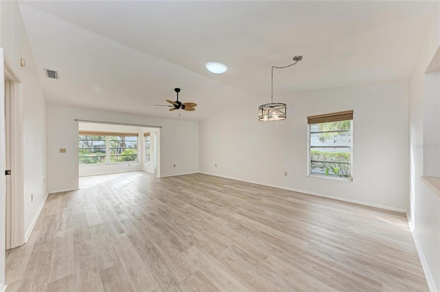 spare room with vaulted ceiling, ceiling fan, plenty of natural light, and light wood-type flooring