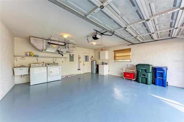 garage featuring water heater, separate washer and dryer, sink, electric panel, and a garage door opener