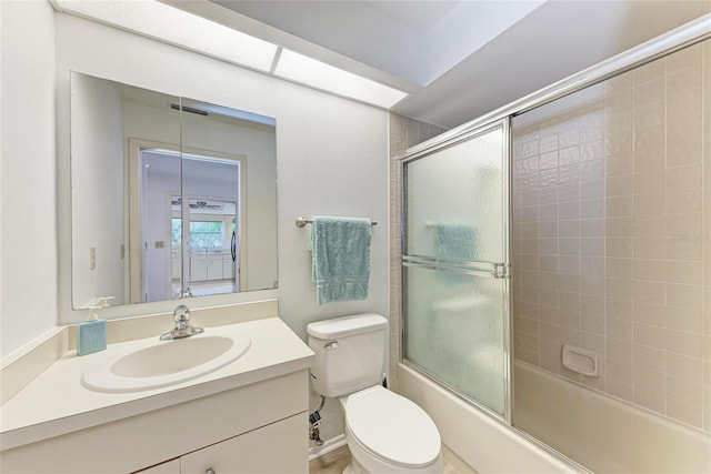 full bathroom featuring shower / bath combination with glass door, vanity, and toilet