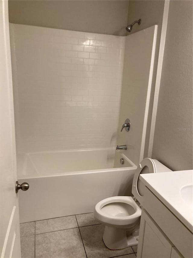 bathroom featuring toilet, tub / shower combination, tile patterned flooring, and vanity