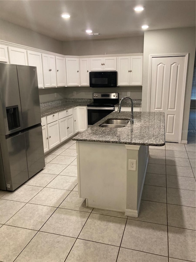 kitchen with sink, stainless steel fridge with ice dispenser, electric range, a kitchen island with sink, and white cabinets