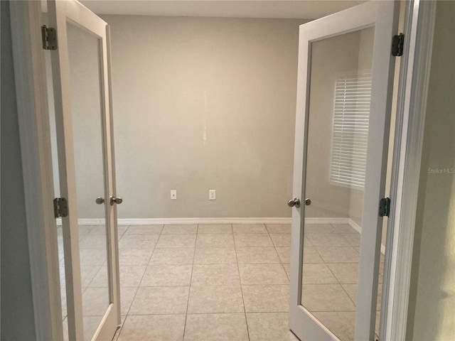 interior space with light tile patterned floors and french doors