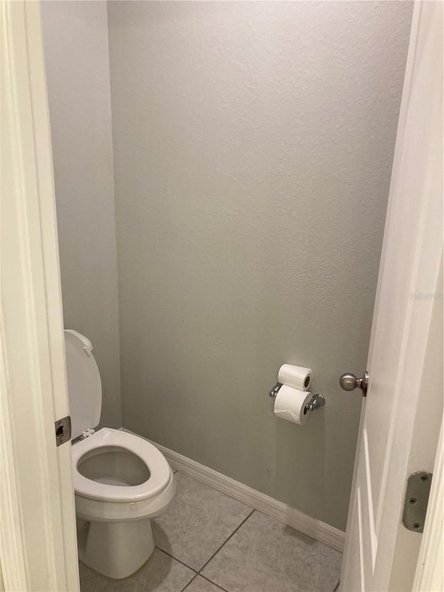 bathroom featuring tile patterned floors and toilet