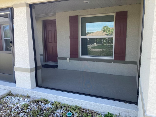 doorway to property with stucco siding