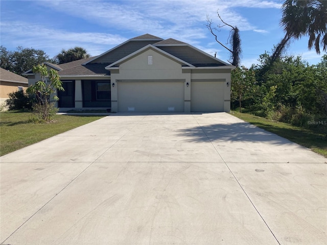 view of front of home featuring a garage, concrete driveway, a front lawn, and stucco siding