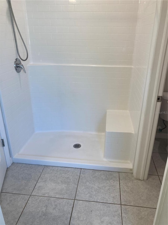 full bathroom with a shower stall and tile patterned floors