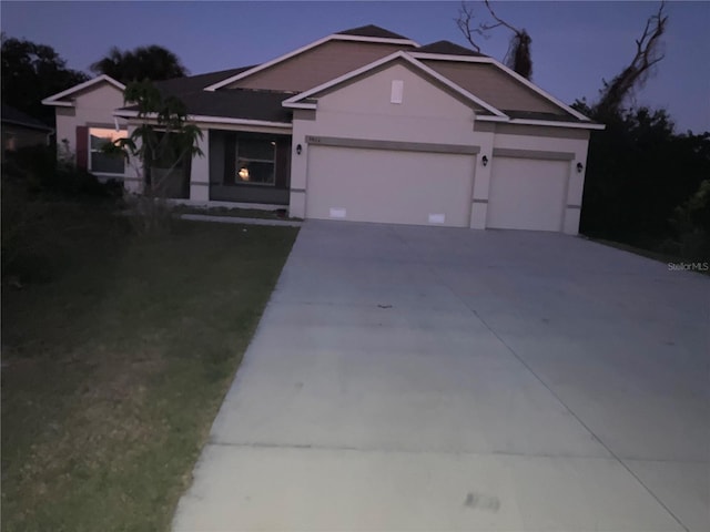 view of front facade featuring driveway and stucco siding