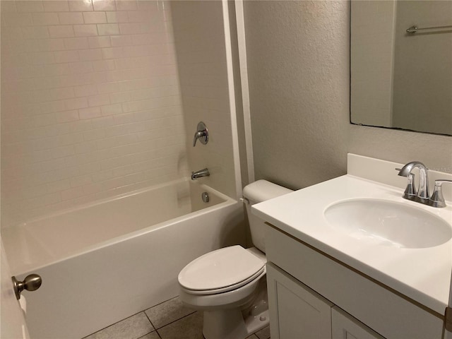 bathroom featuring a textured wall, toilet, tile patterned flooring, vanity, and washtub / shower combination