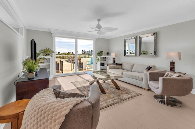 living room featuring hardwood / wood-style floors, ornamental molding, and ceiling fan