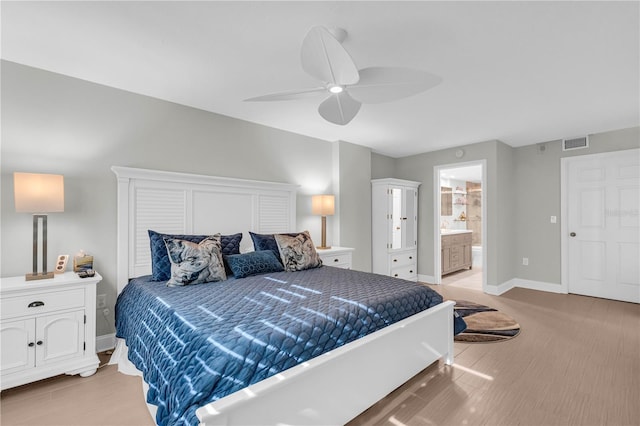 bedroom with ceiling fan, ensuite bathroom, and light hardwood / wood-style flooring